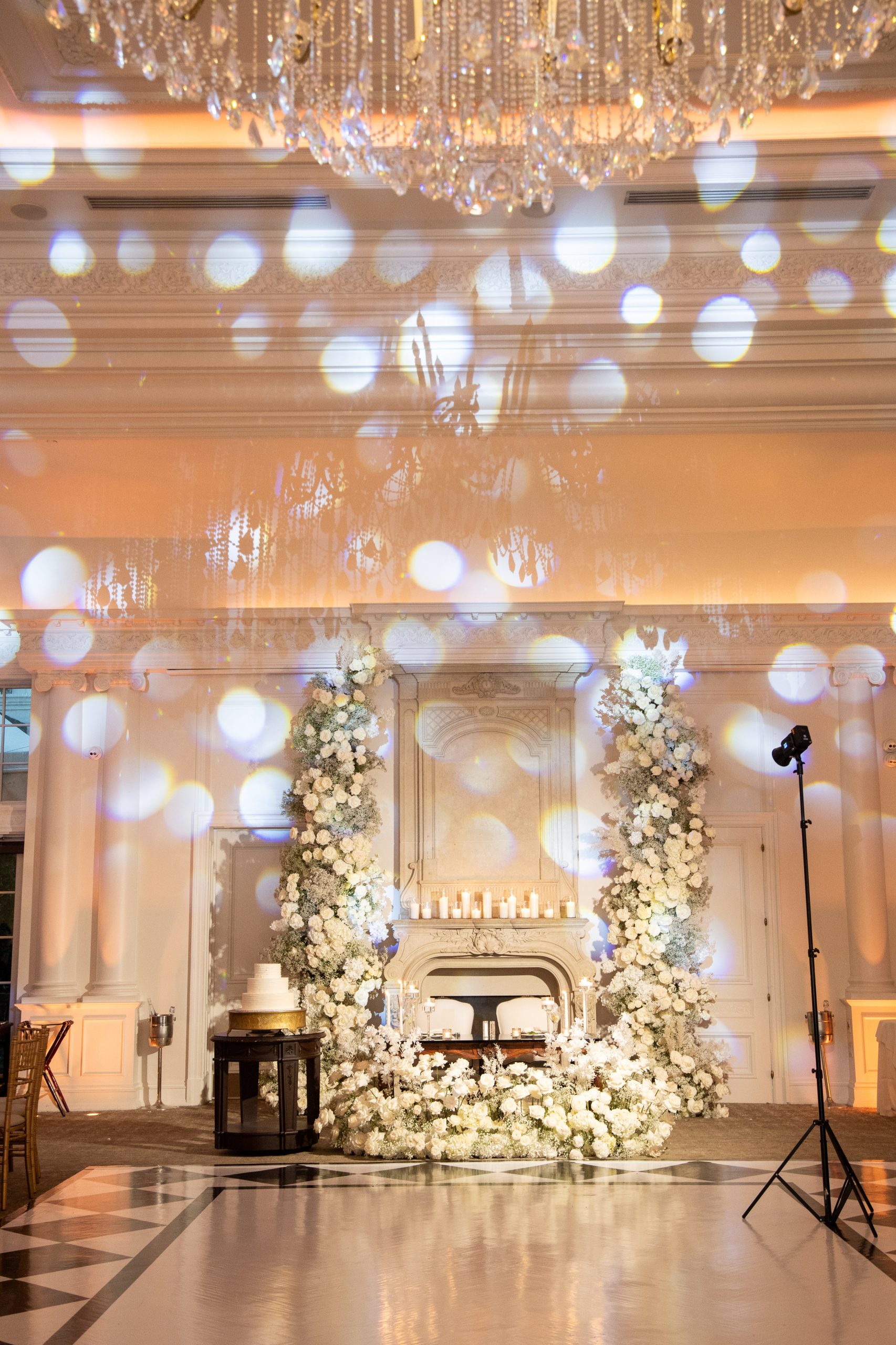 all white flowers at a wedding reception in a ballroom