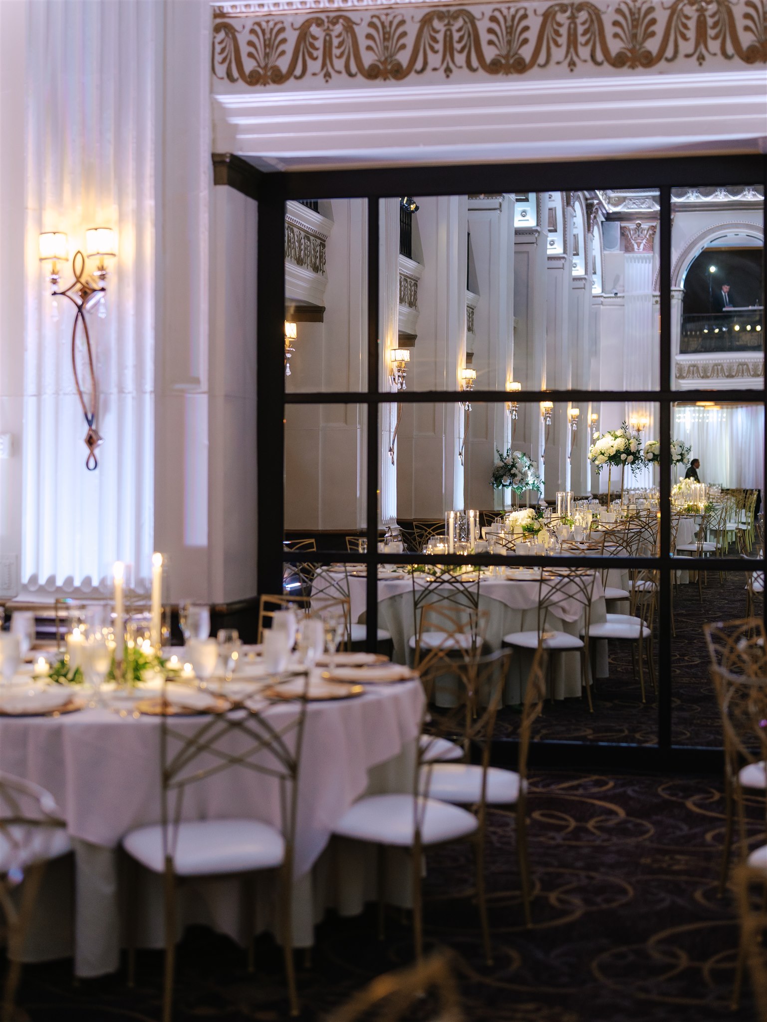 corner of a ballroom at a wedding with a mirror