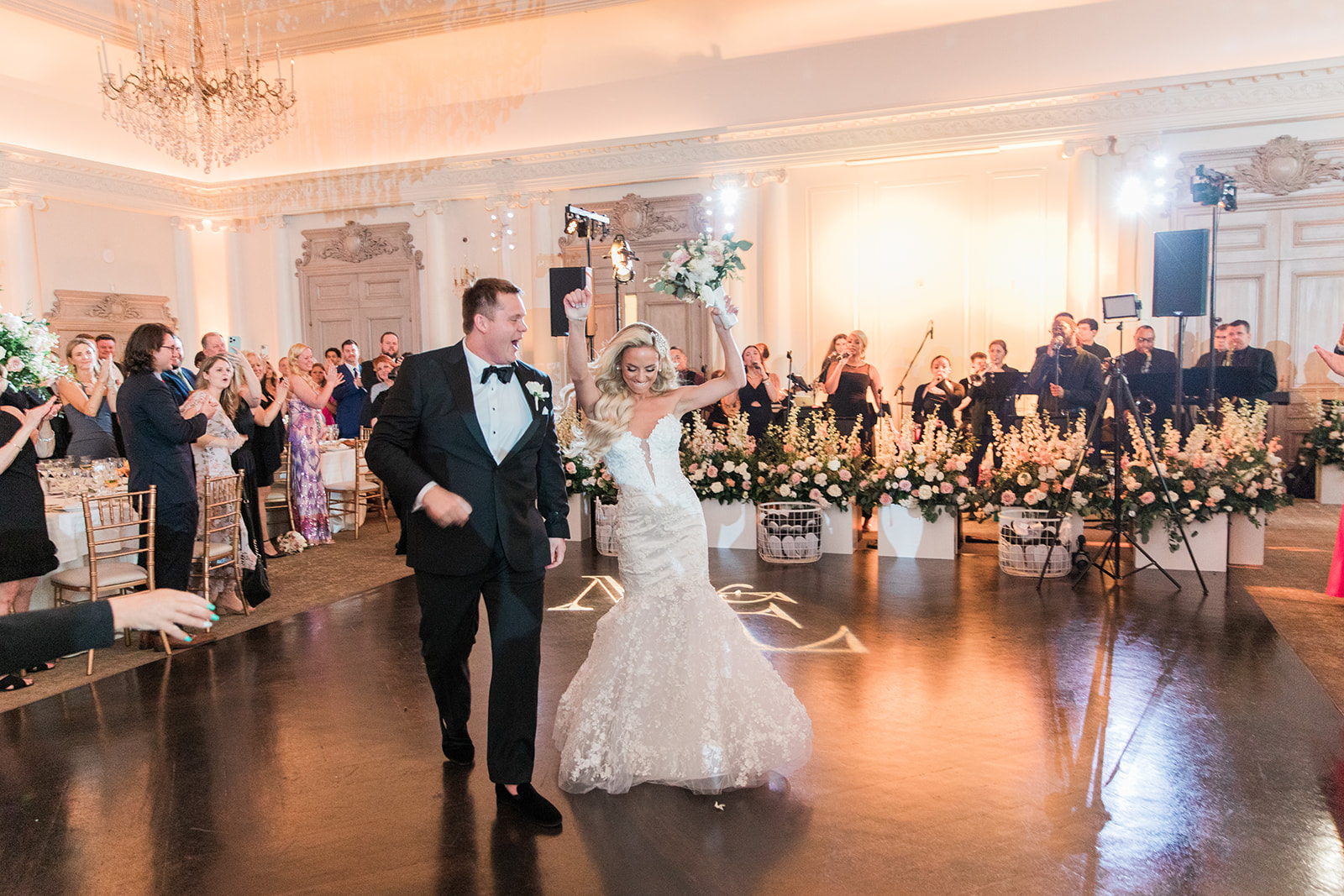 bride and groom coming into the reception