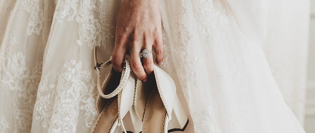 bride holding shoes