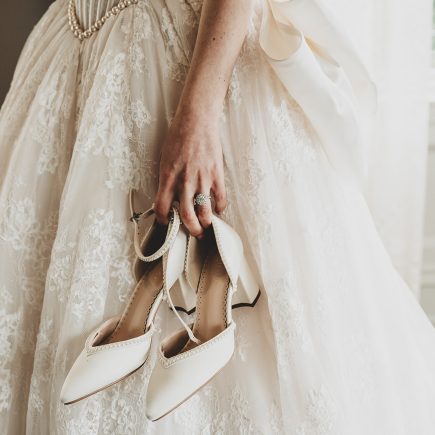 bride holding shoes