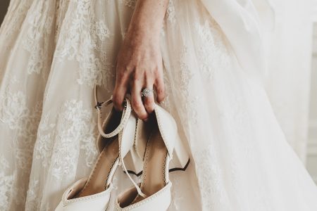 bride holding shoes