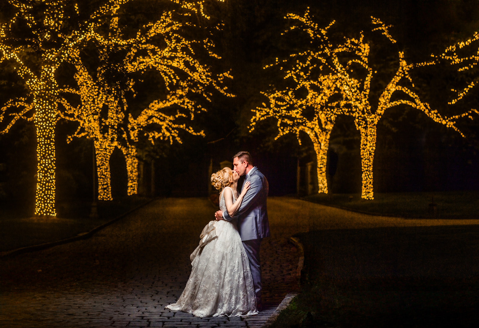 bride and groom outside with christmas lights