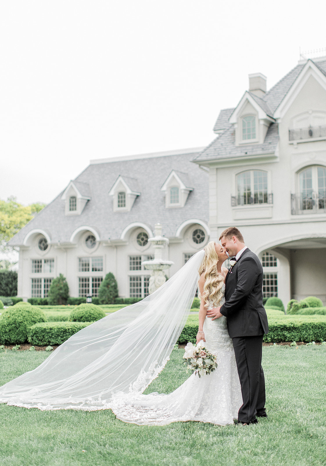 bride and groom in front of park chateau