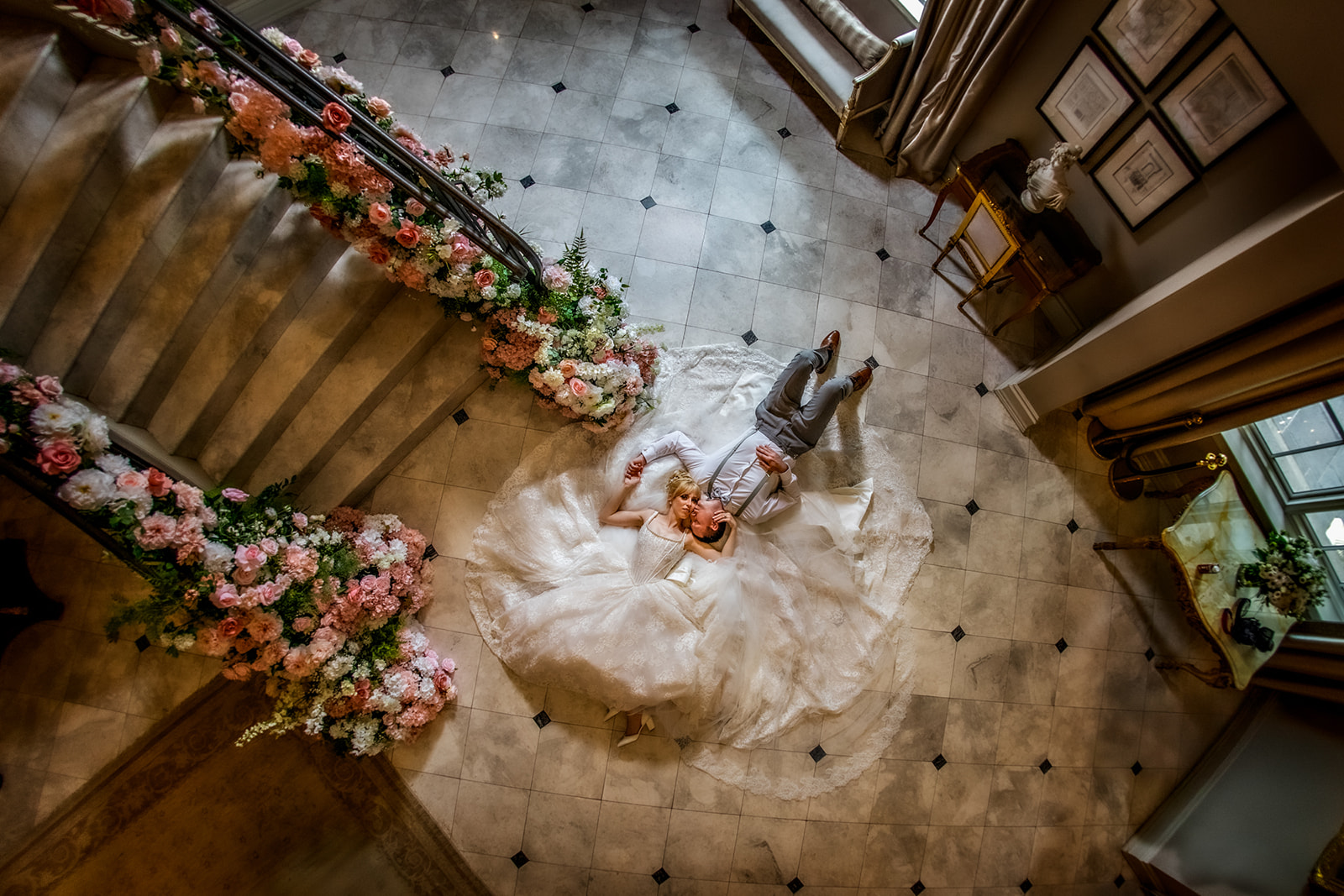 bride and groom laying on floor looking up