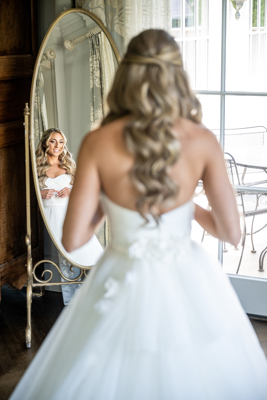 bride looking at herself in the mirror