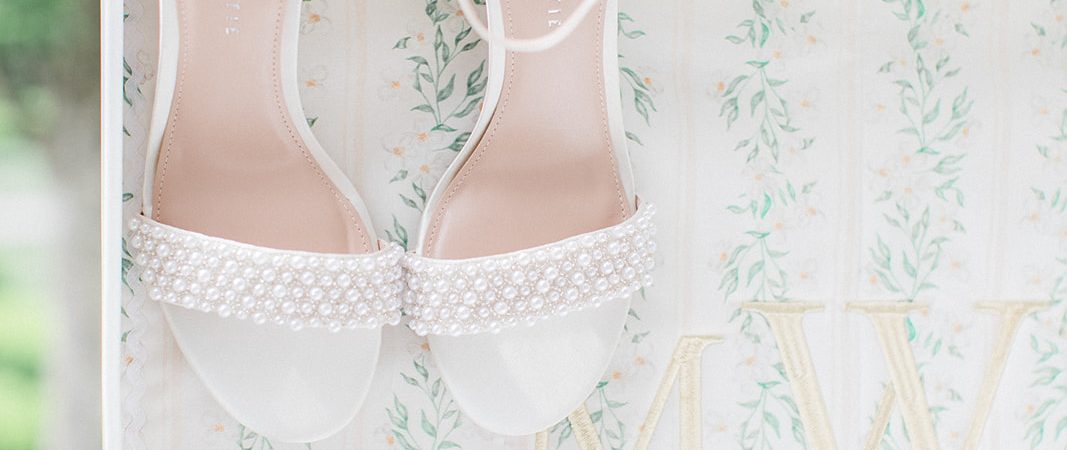 bridal shoes hanging on suitcase