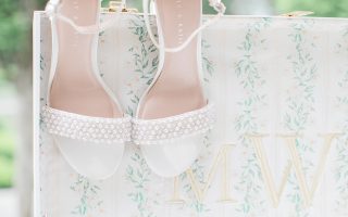 bridal shoes hanging on suitcase