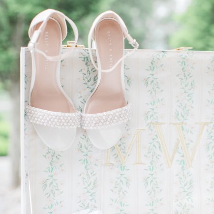 bridal shoes hanging on suitcase