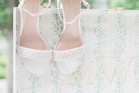 bridal shoes hanging on suitcase