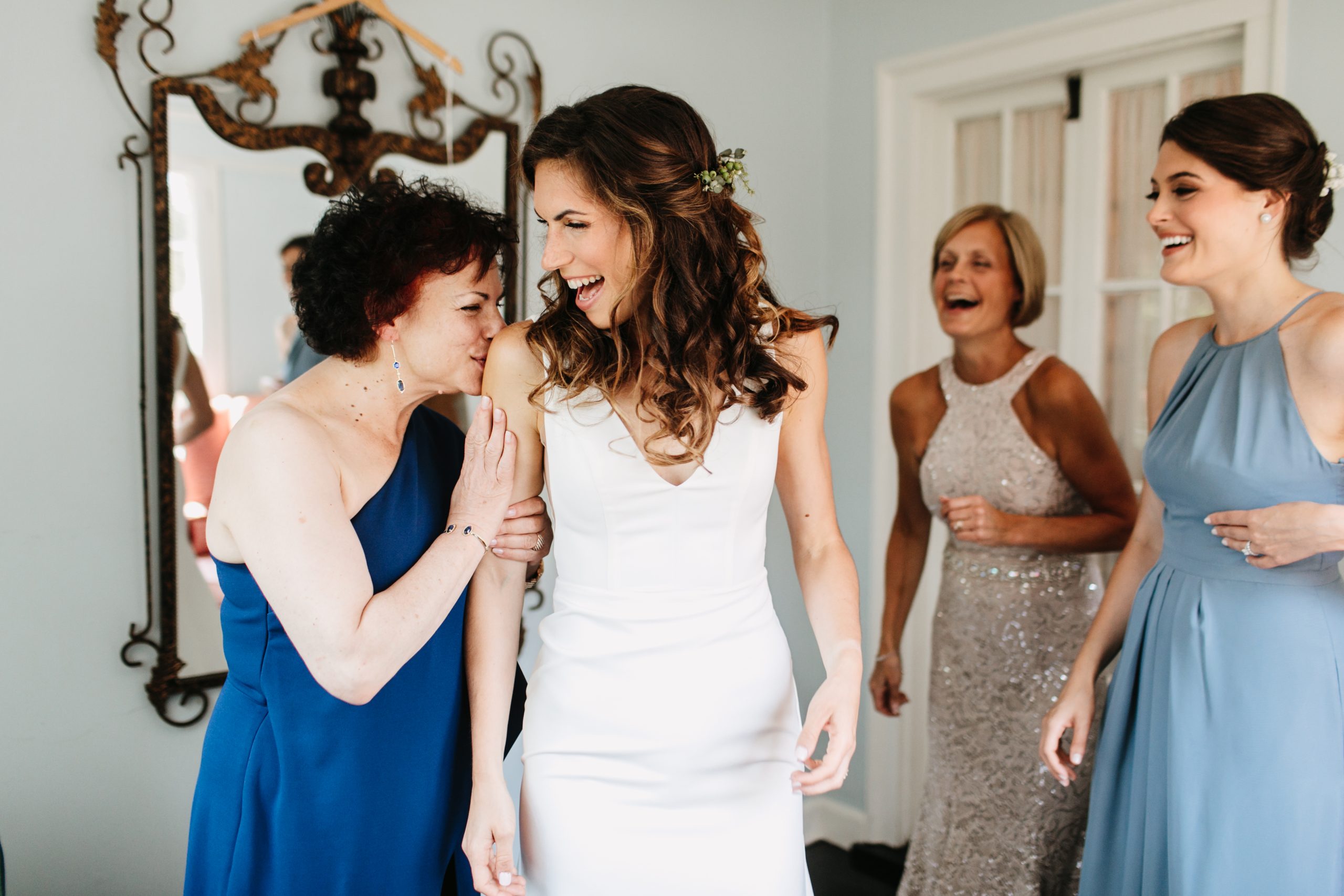 bride getting ready with her mom and bridesmaids