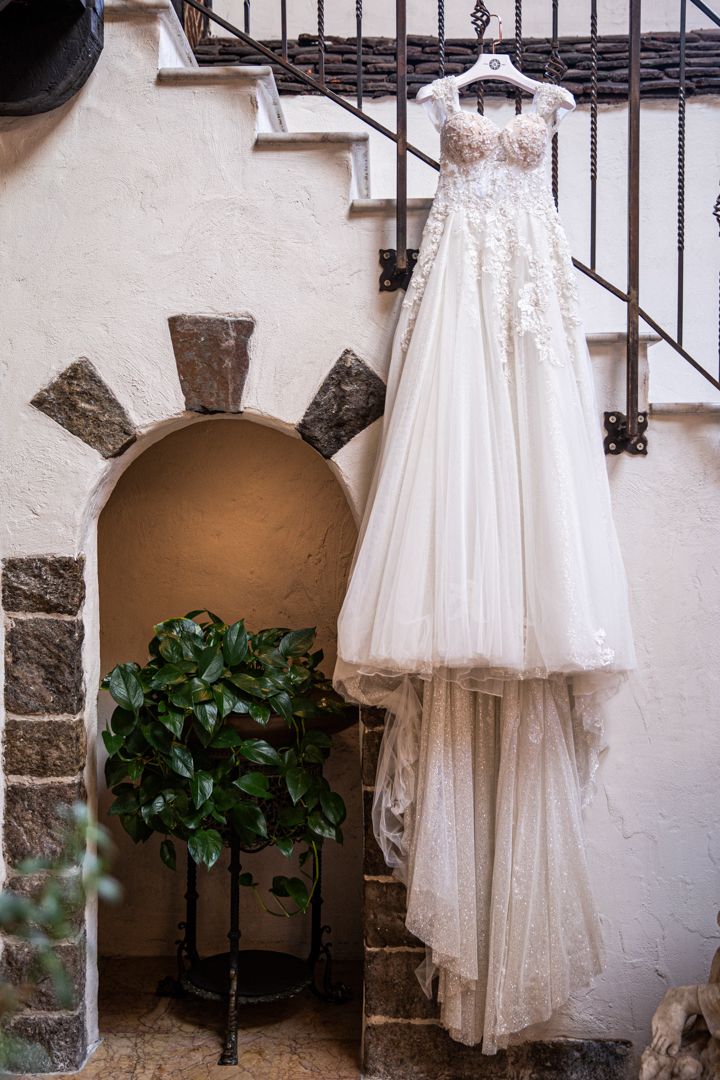 wedding gown hanging up on stairs