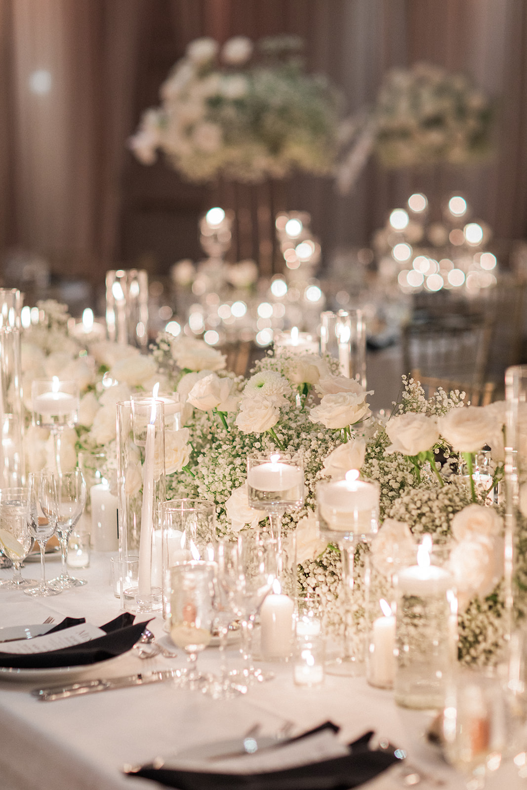 table at wedding with white flowers and candles