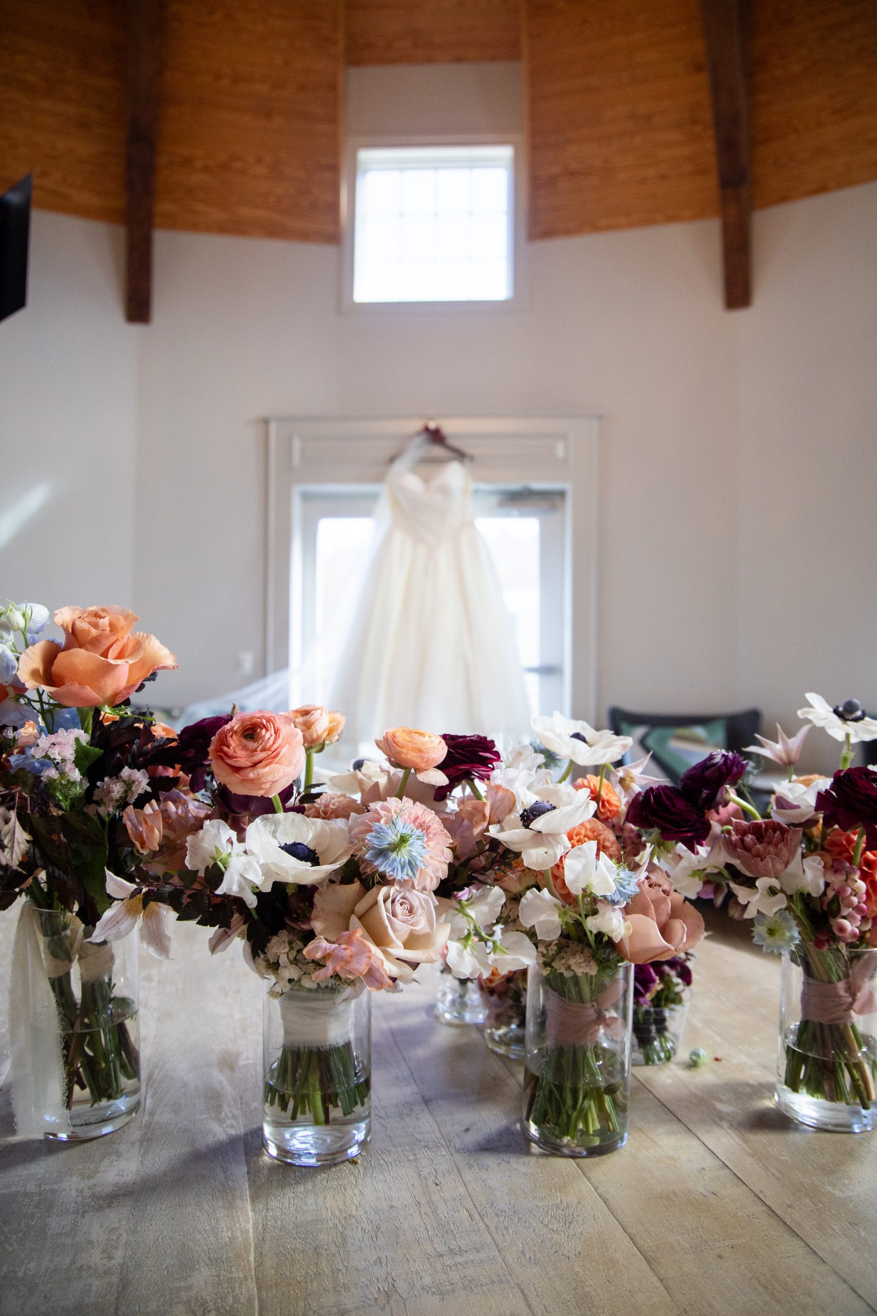 bouquets in front of bridal gown