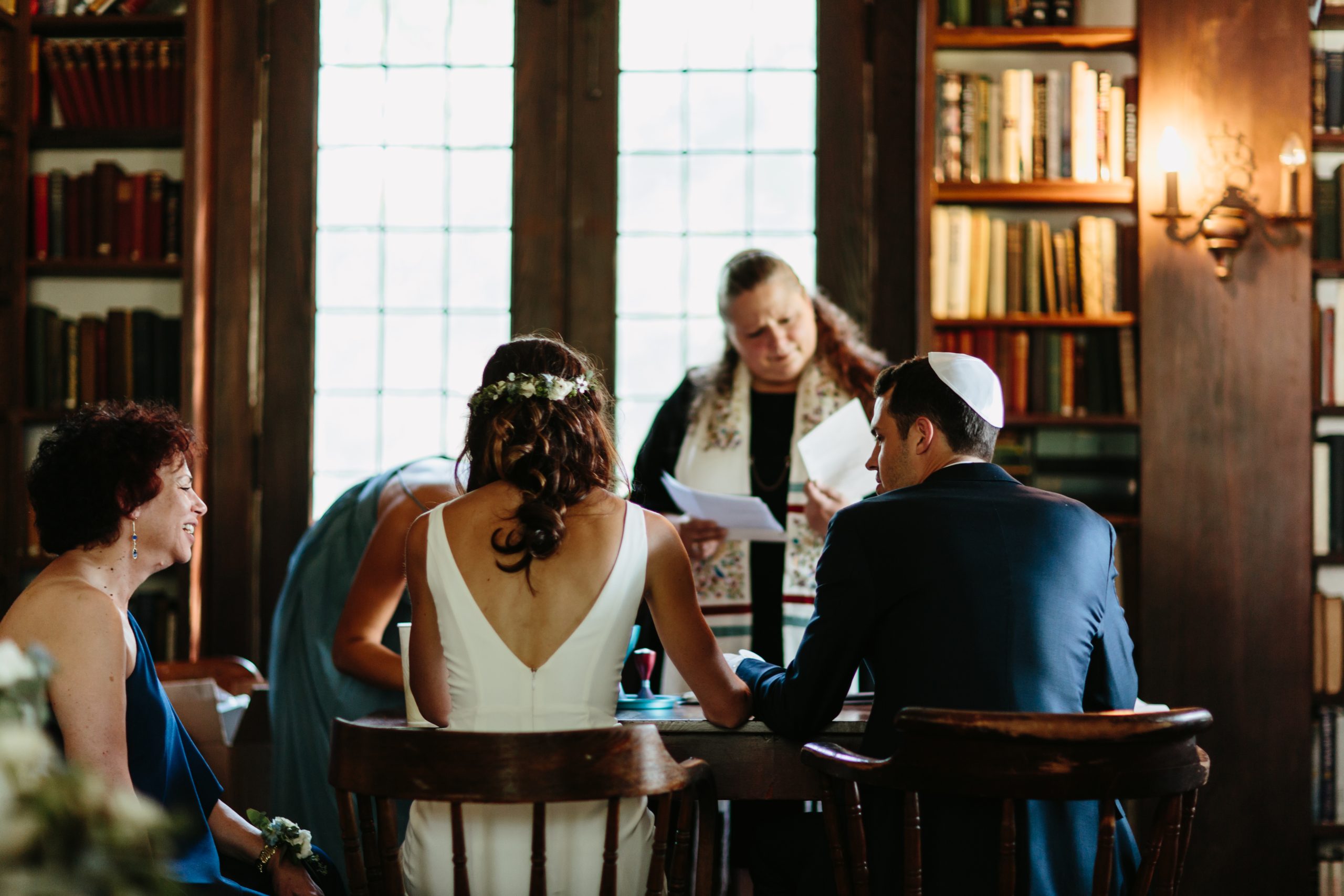 bride and groom signing ketubah