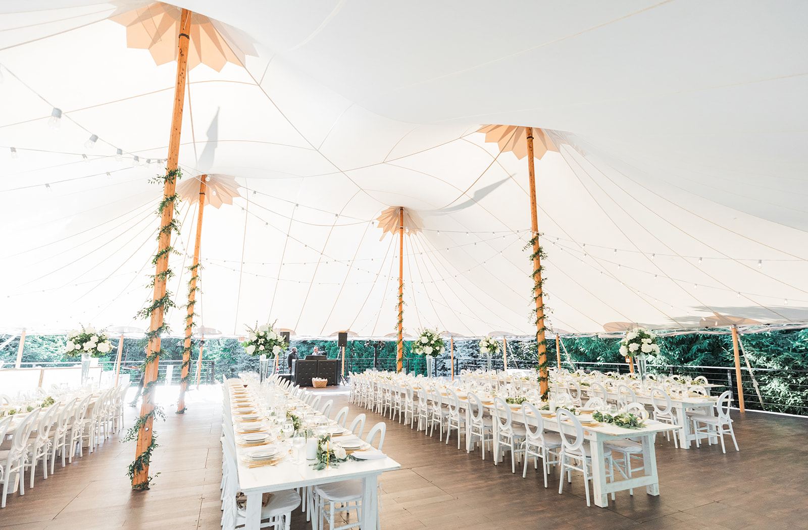 inside of wedding tent with tables and centerpieces