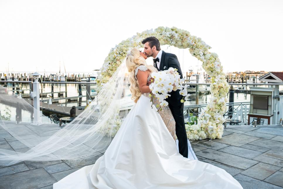 bride and groom in front of altar with white flowers