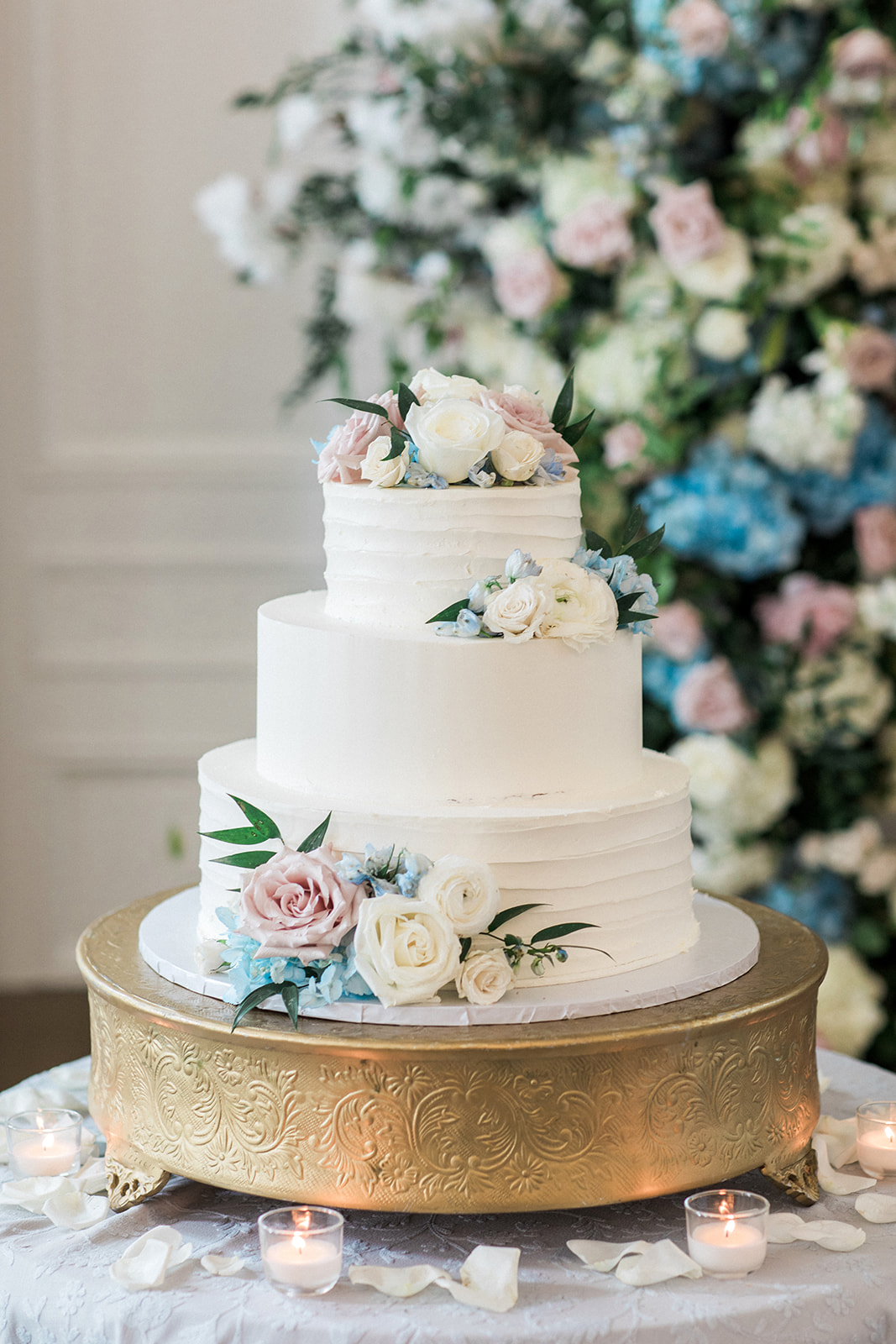 wedding cake with pink white and blue florals