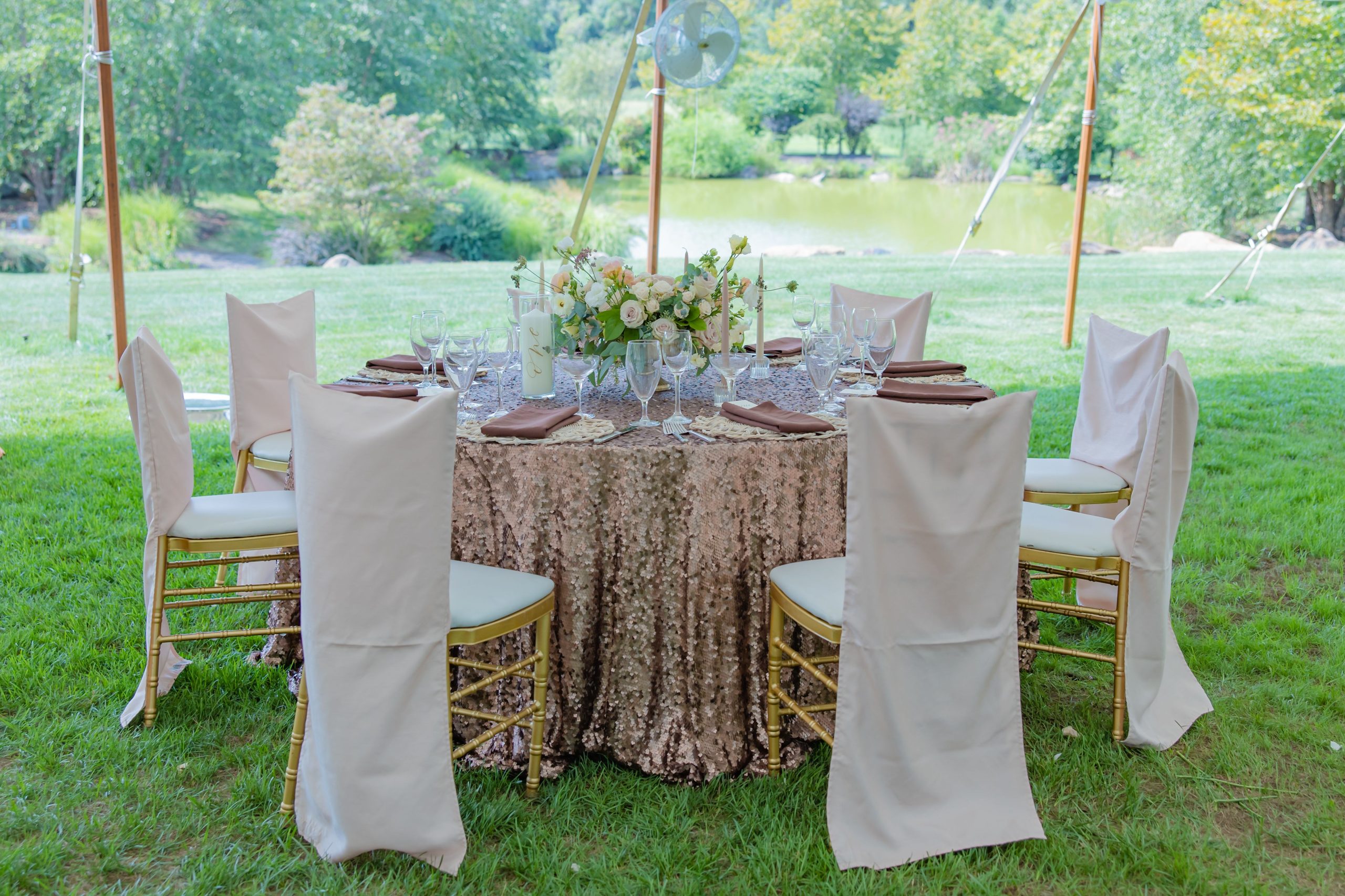 brown sequin table with chairs and covers under tent