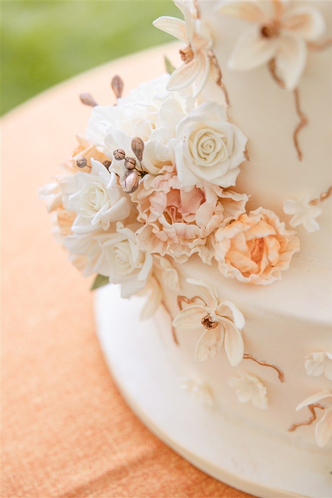 white wedding cake with pale peach sugar flowers